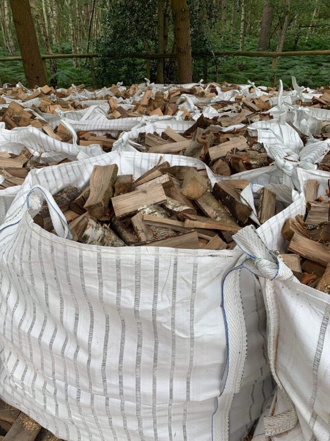 Bulk bags of split hardwood logs in the yard